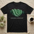 Black t-shirt with green arboreal snake coiled on branch design and text.