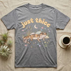 African Fat-Tailed Gecko Softie T-Shirt in Sport Grey — African fat-tailed gecko with a plump tail under a puffy pastel "just thicc" bubble wordmark with tiny hearts.