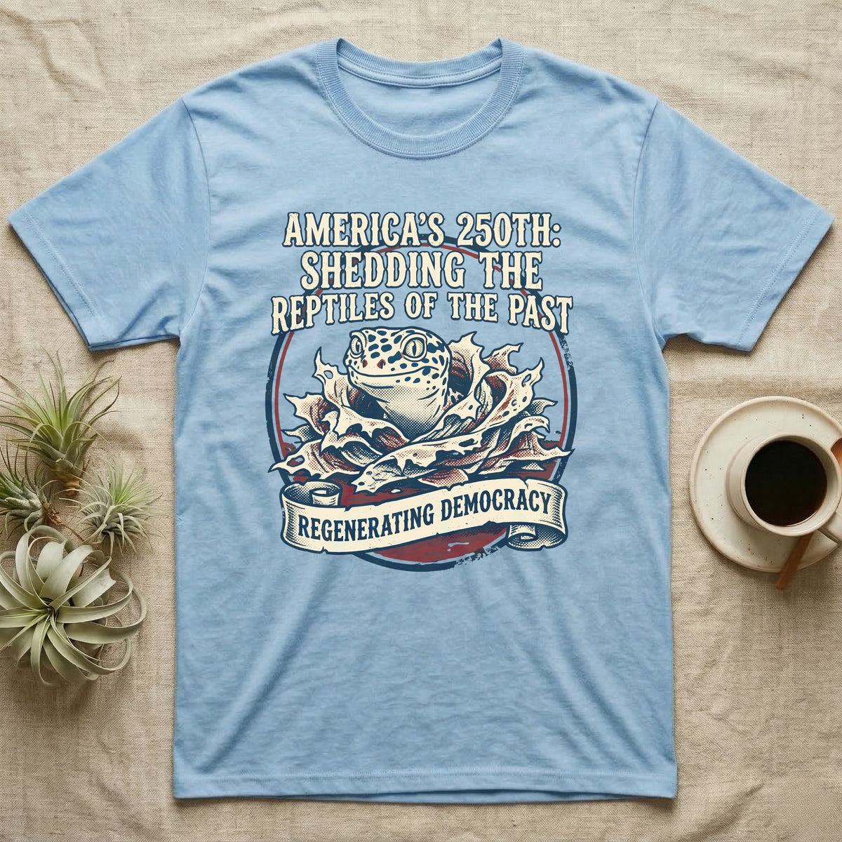 Leopard Gecko Shedding Tee in Light Blue — Vintage badge of a leopard gecko emerging from its shed skin, navy and red emblem reading Shedding The Reptiles Of The Past, on black.
