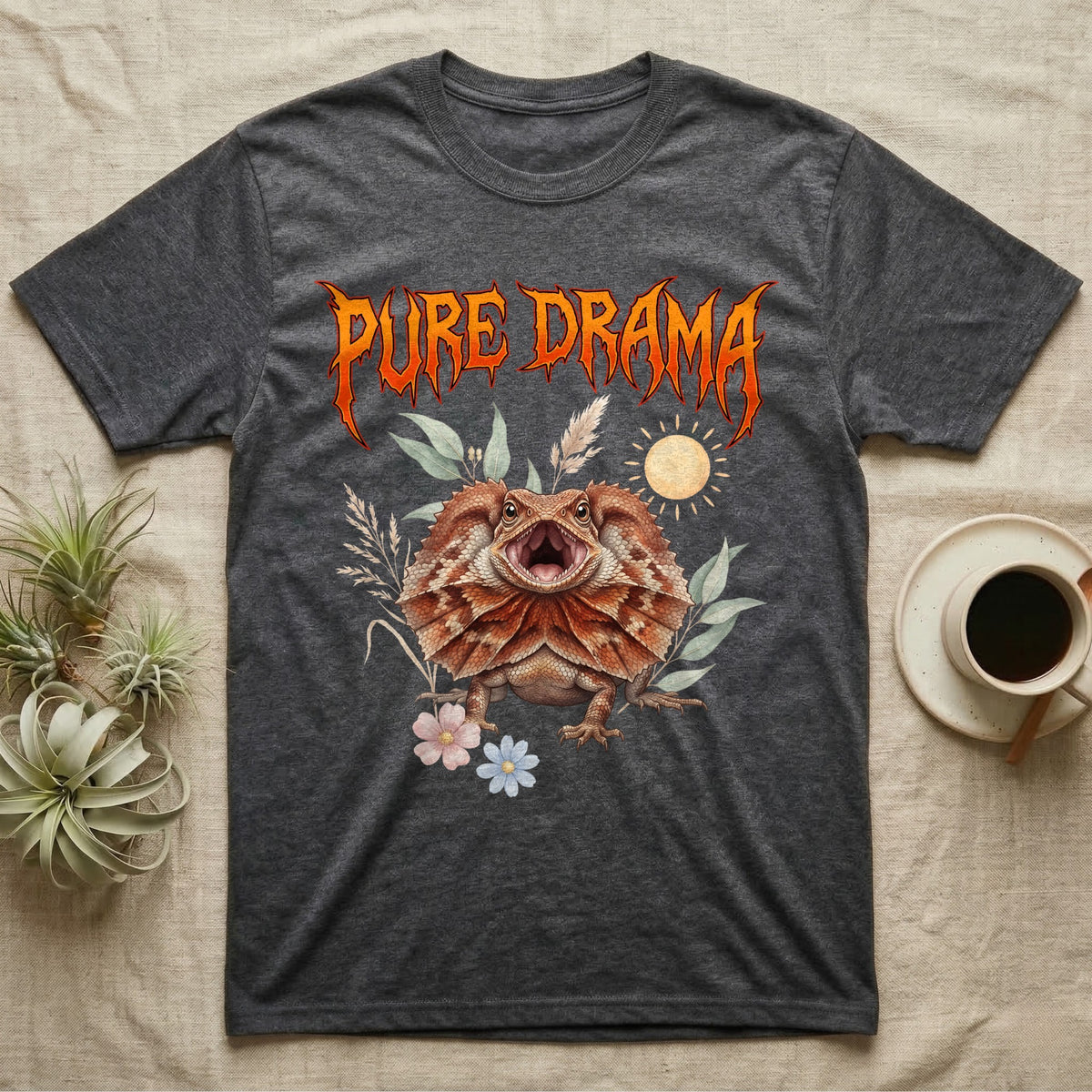 Frilled Dragon Feral T-Shirt in Dark Heather — Frilled dragon with its neck frill flared and mouth gaping under a jagged fiery-orange metal "PURE DRAMA" wordmark.