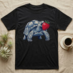 Sulcata Strawberry Tortoise T-Shirt in Black — Bold vector illustration of a sulcata tortoise lunging neck-first toward an oversized red strawberry, head-on view.