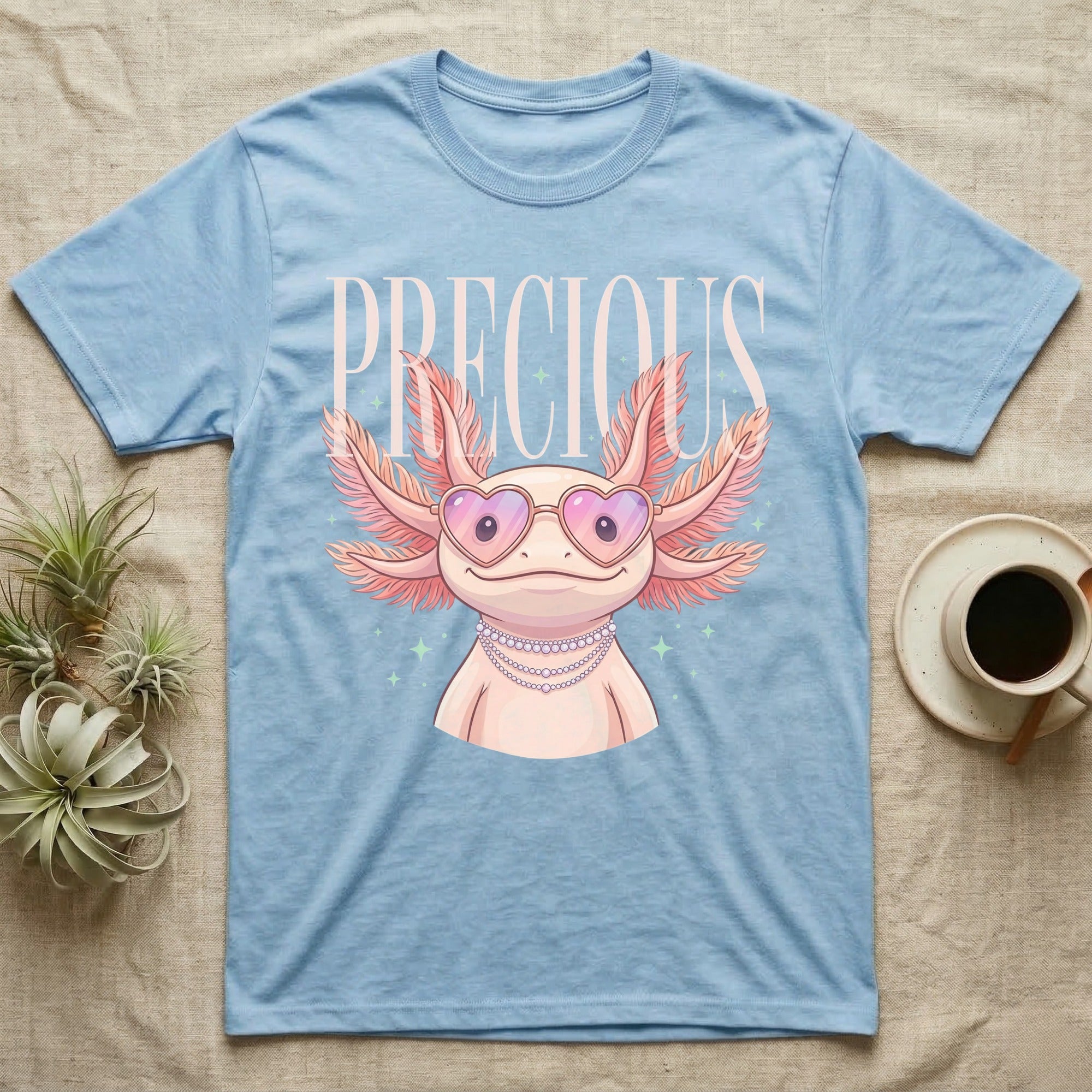 Light blue t-shirt with cartoon axolotl wearing heart-shaped sunglasses and text "PRECIOUS".