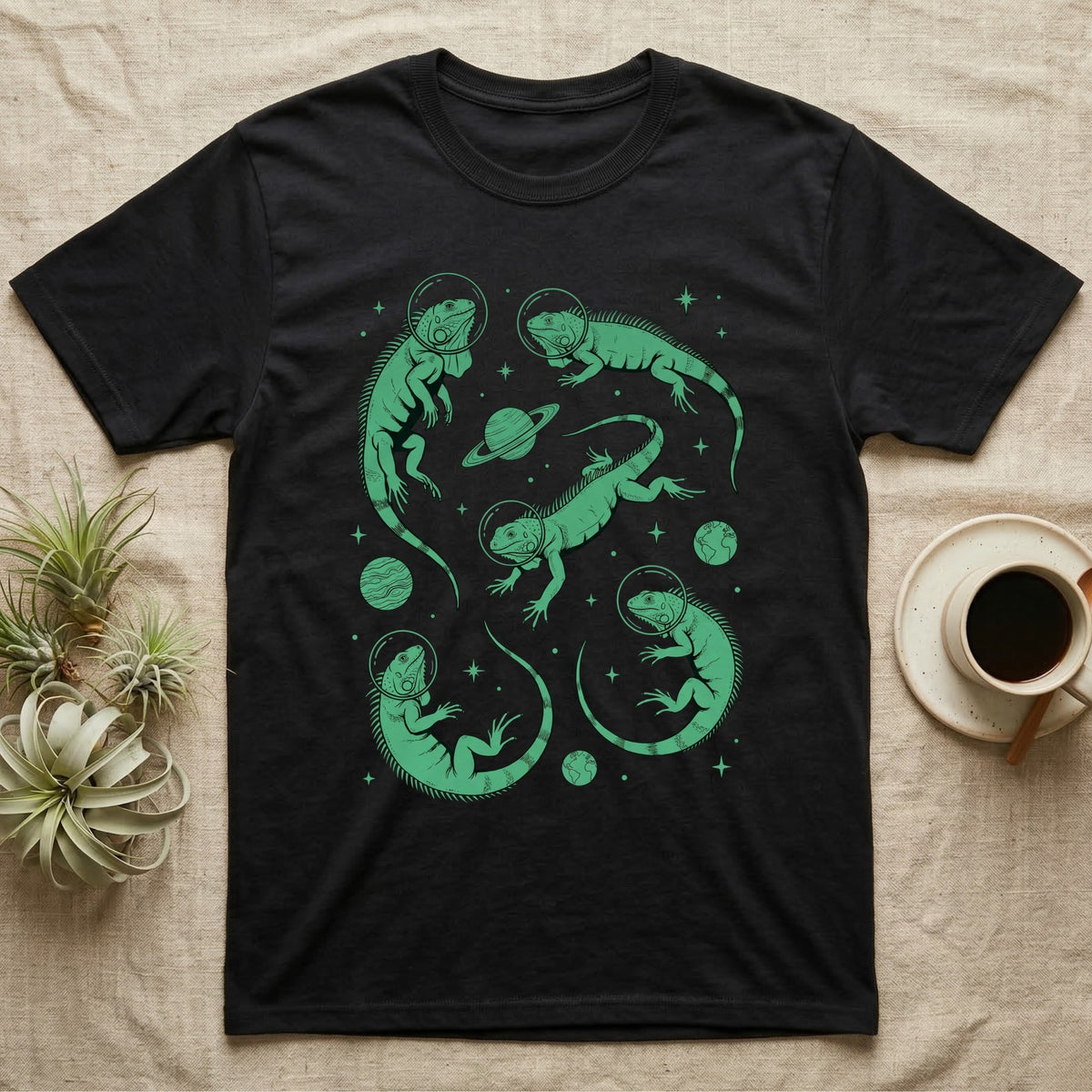 Green Iguana Cosmic T-Shirt in Black — Vintage screen-print illustration of green iguanas in astronaut helmets floating in space, cosmic emerald green monochromatic on dark background.