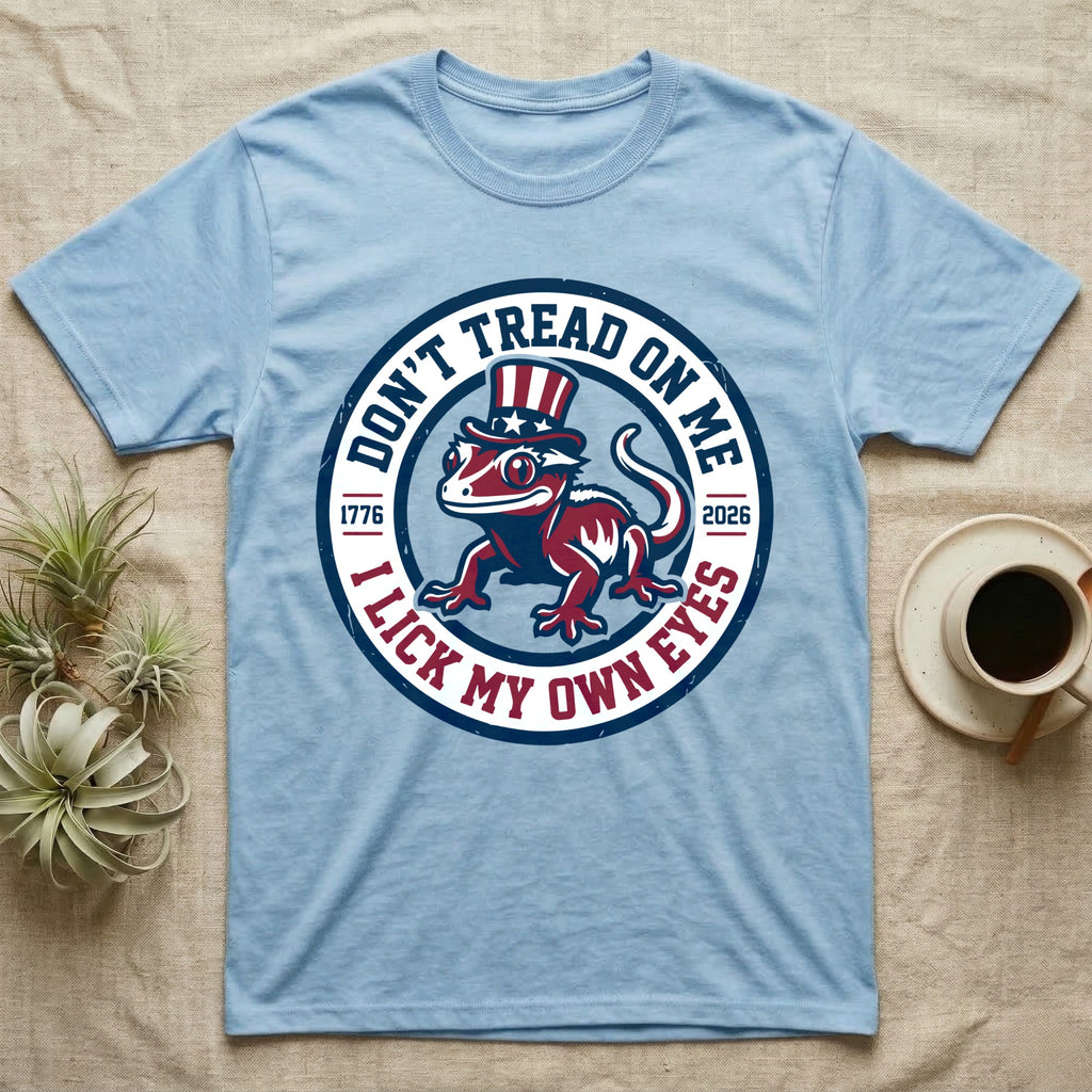 Crested Gecko 1776 T-Shirt in Light Blue — Distressed crest of a crested gecko in a top hat with text Don't Tread On Me and I Lick My Own Eyes.