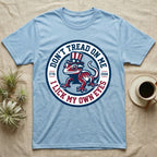 Crested Gecko 1776 T-Shirt in Light Blue — Distressed crest of a crested gecko in a top hat with text Don't Tread On Me and I Lick My Own Eyes.
