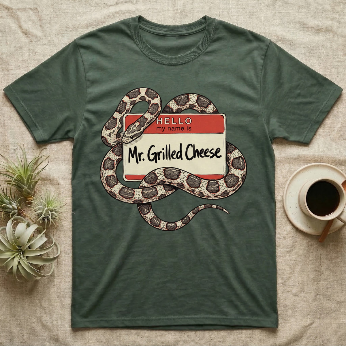 Grilled Cheese Corn Snake T-Shirt in Military Green — Flat retro illustration of a corn snake coiled through a "Hello my name is Mr. Grilled Cheese" name-tag badge.