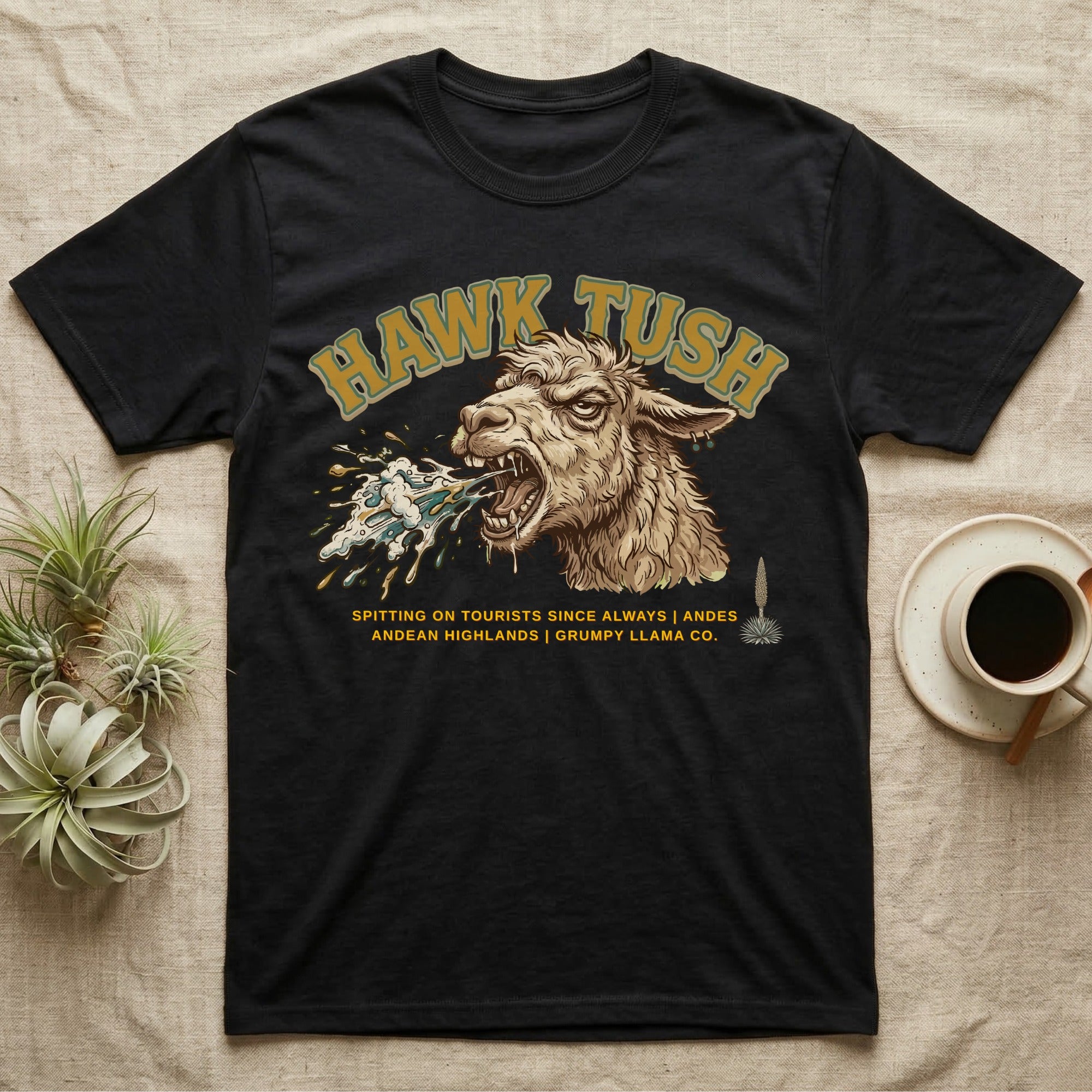 Black t-shirt with a llama spitting, text "Hawk Tush".