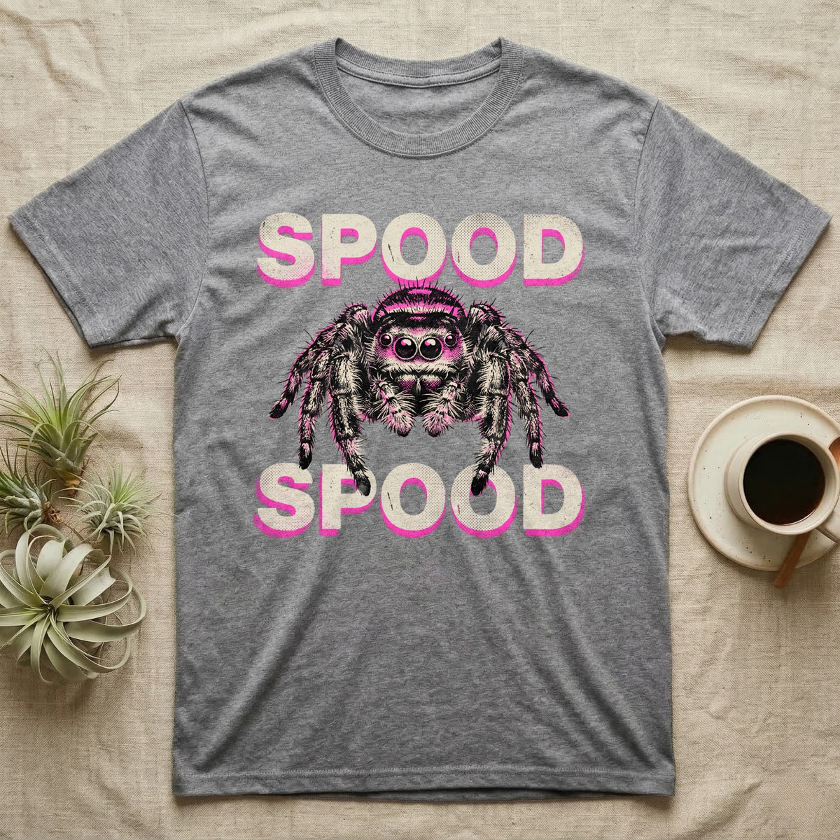 Spood Jumping Spider T-Shirt in Sport Grey — Grunge-punk illustration of an oversized front-facing jumping spider with a distressed "Spood" wordmark in bone and acid pink.