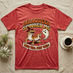 Leopard Gecko Spooked Me T-Shirt in Heather Red — Distressed graphic of a shocked leopard gecko in a witch hat beside its ghost-costumed dropped tail, "Halloween Spooked Me."