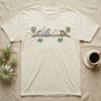 Amazon Milk Frog Branch T-Shirt in Natural — Four banded Amazon milk frogs perched along one slender branch, drawn in loose ink line and soft watercolour wash.