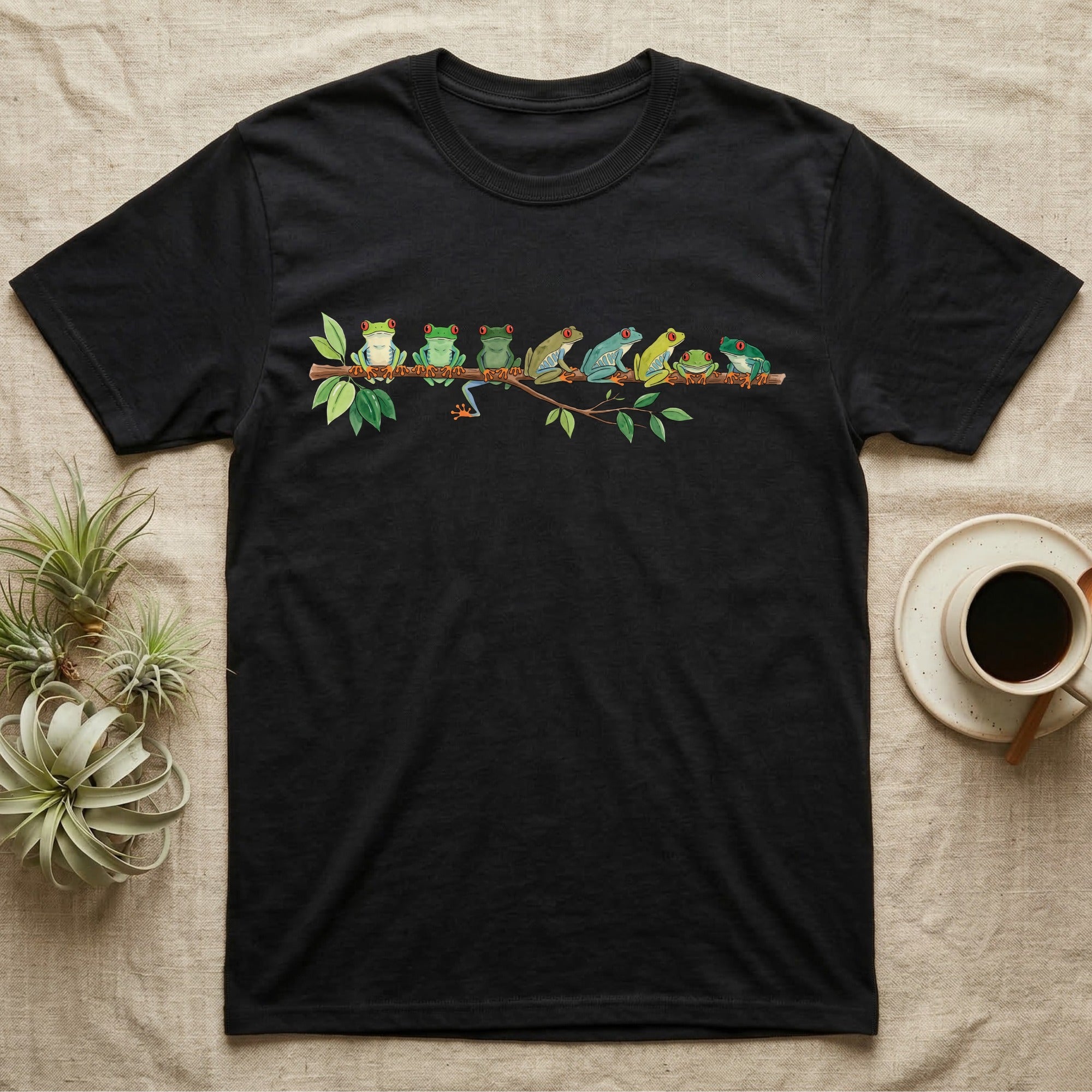 Red-Eyed Tree Frog Canopy Crew T-Shirt in Black — Watercolor illustration of seven red-eyed tree frogs in varied green hues on a branch, dark grey T-shirt design.