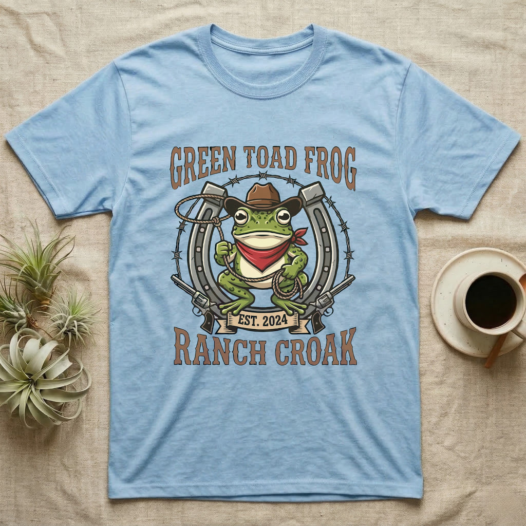 Light blue t-shirt with a cartoon green toad wearing a cowboy hat and bandana.