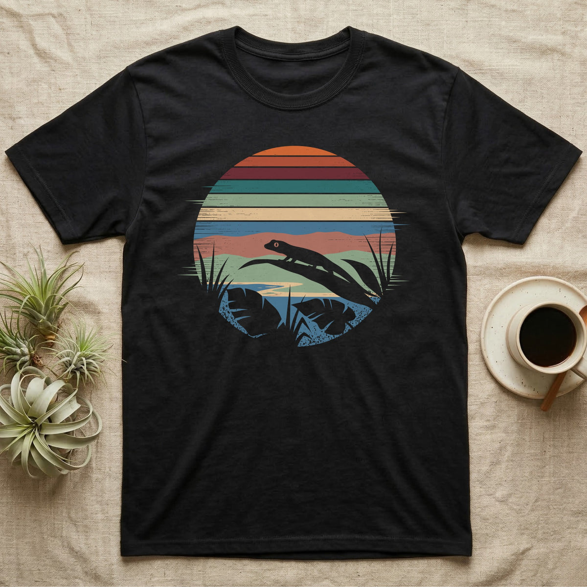 Mourning Gecko Window T-Shirt in Black — Mourning gecko silhouetted on a leaf inside a broken circular window of flat stepped rainforest colour bands.