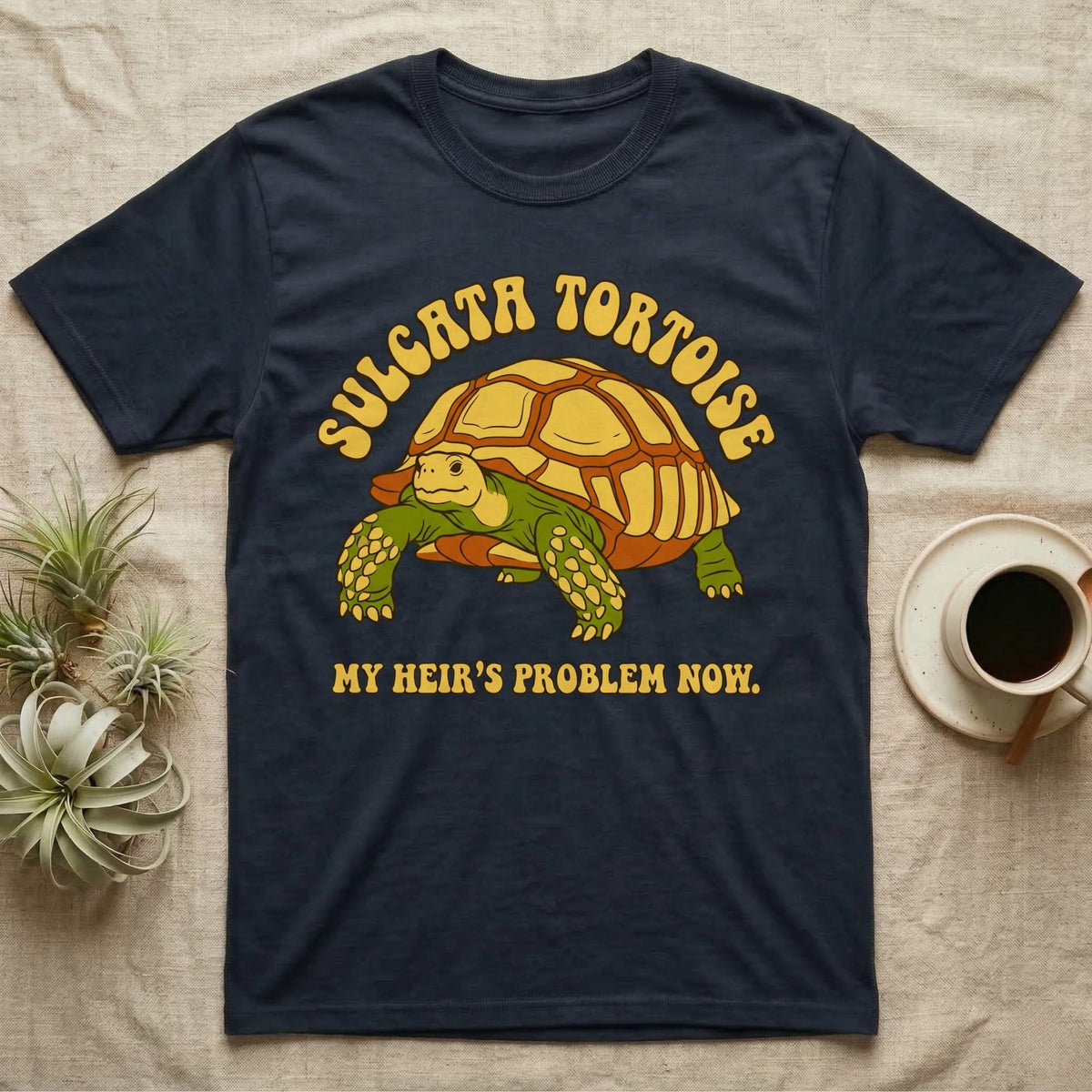 Dark blue t-shirt with a Sulcata tortoise and "MY HEIR'S PROBLEM NOW." text.