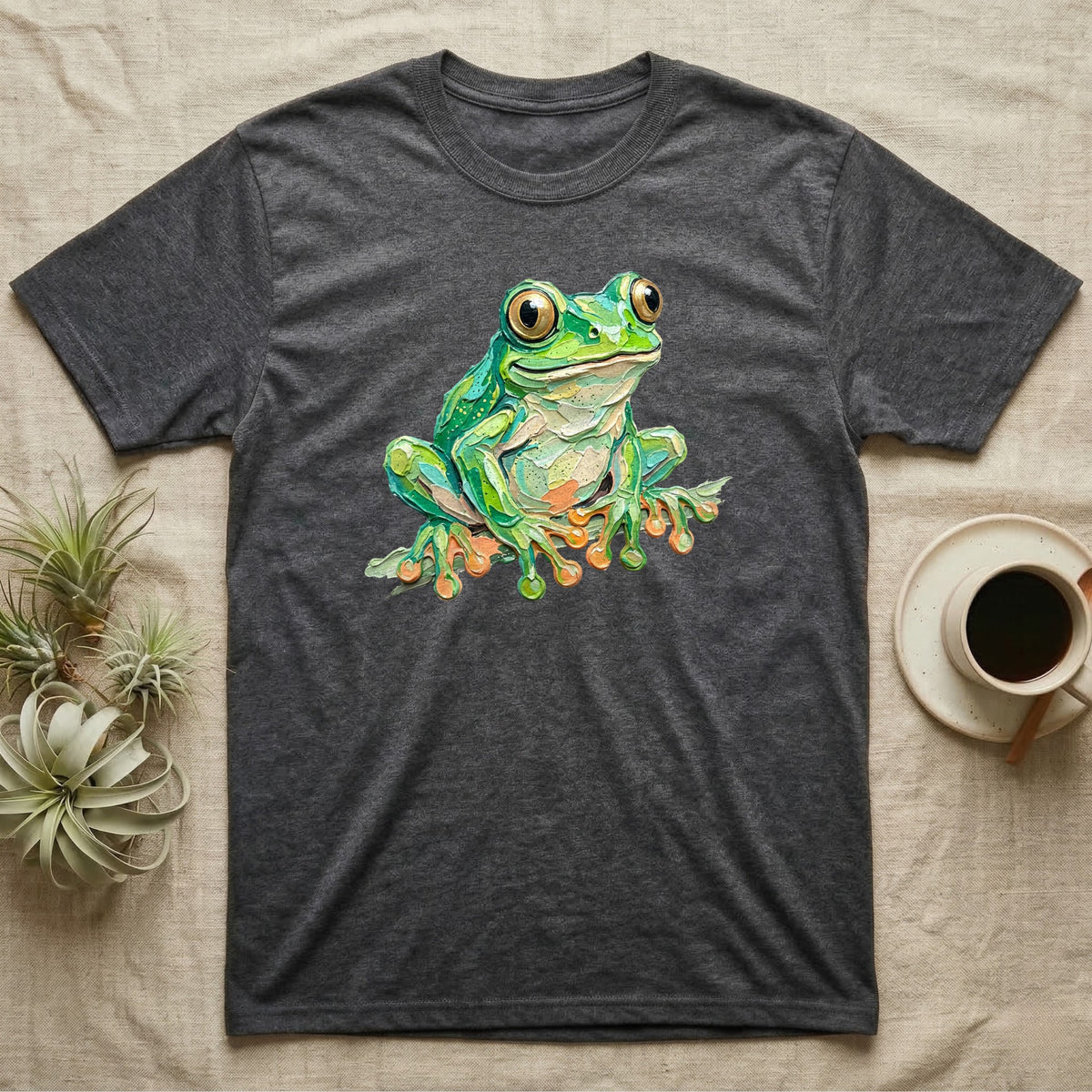 Dark gray t-shirt with a vibrant green frog illustration.