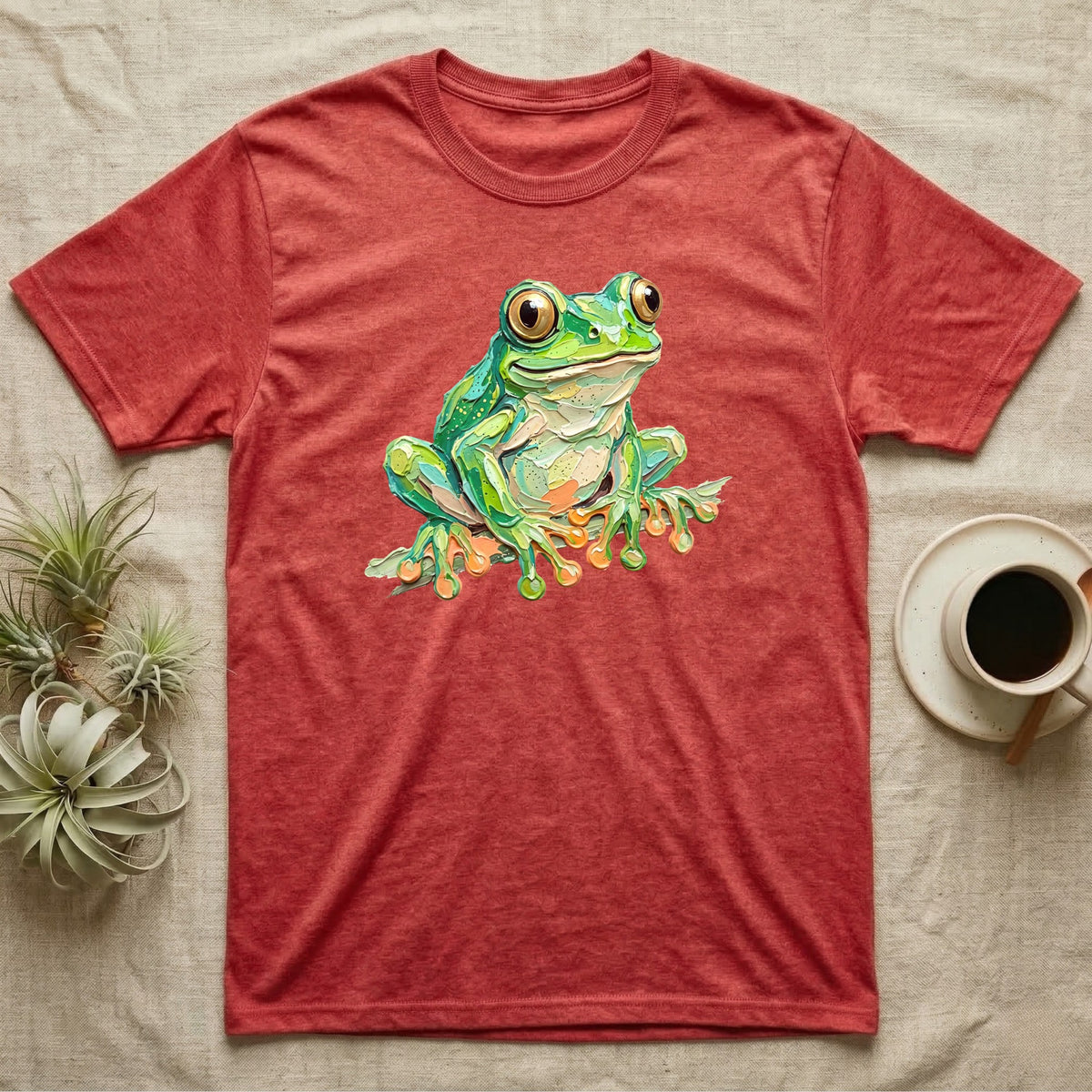 Red t-shirt with a vibrant green frog illustration on the front.