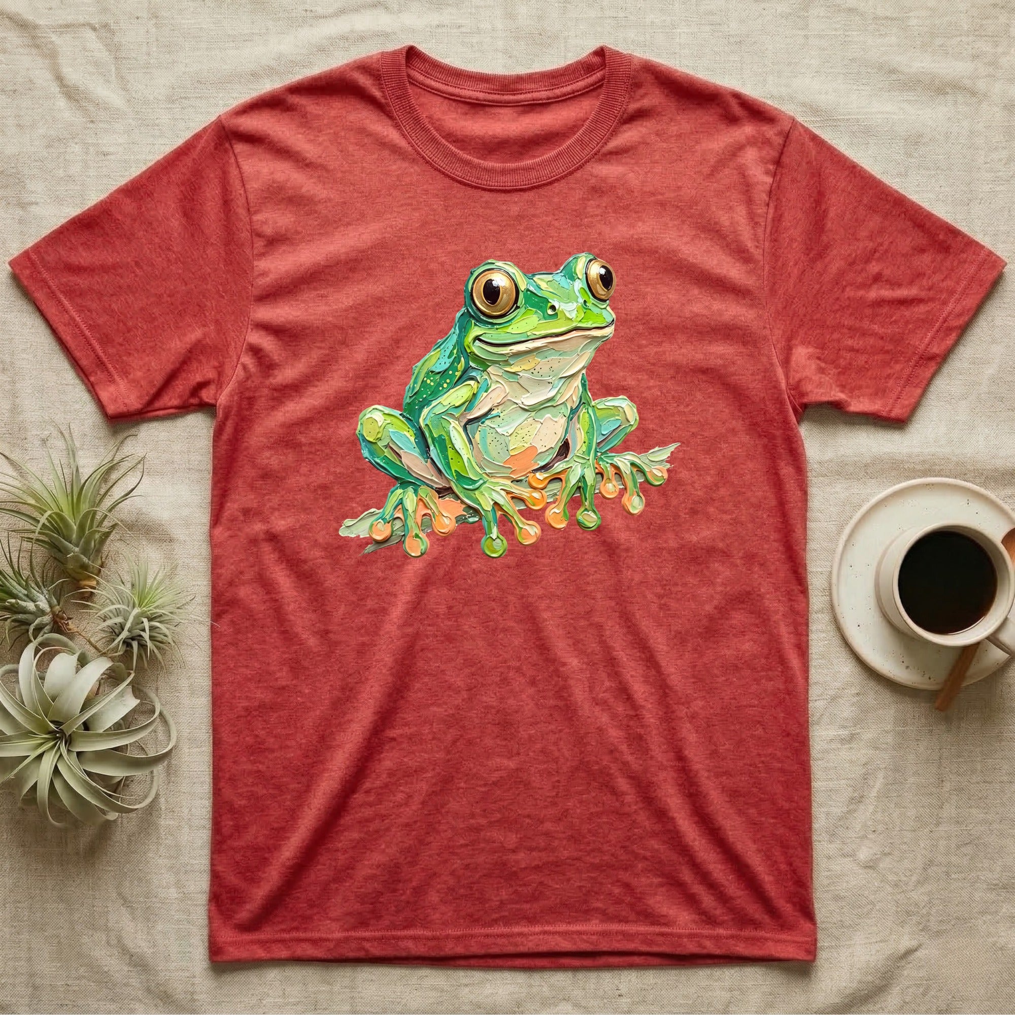 Red t-shirt with a vibrant green frog illustration on the front.