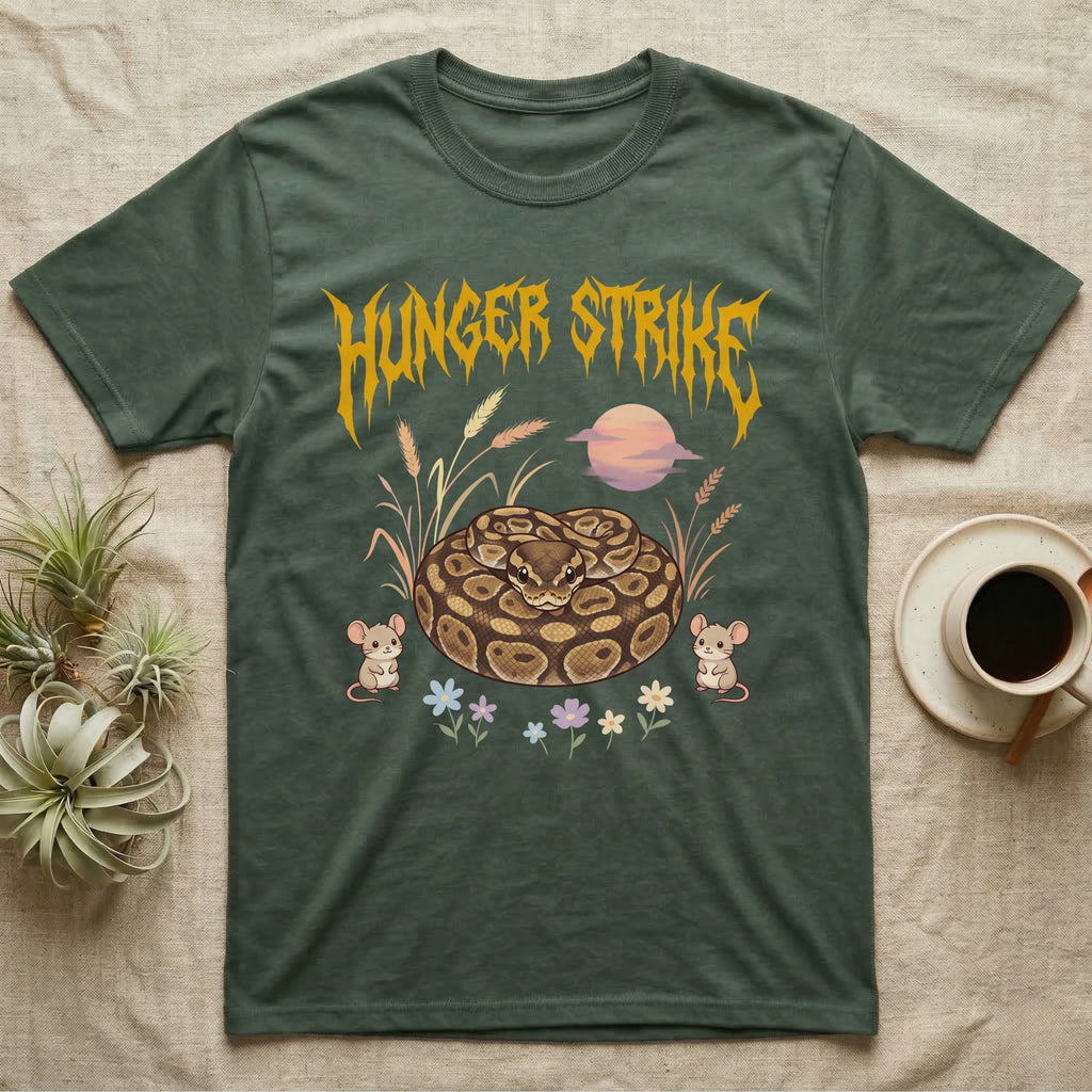 Ball Python Feral T-Shirt in Military Green — Ball python coiled in a loaf in a pastel savanna scene under a spiky honey-gold metal wordmark reading HUNGER STRIKE.
