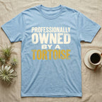 Owned By A Tortoise T-Shirt in Light Blue — Distressed woodtype wordmark reading professionally owned by a tortoise in a bold two-tier lockup, text only.