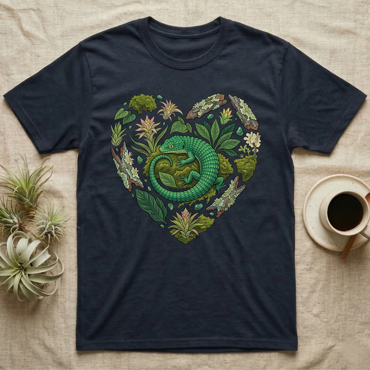 Navy t-shirt with a heart-shaped design of a green lizard and plants.