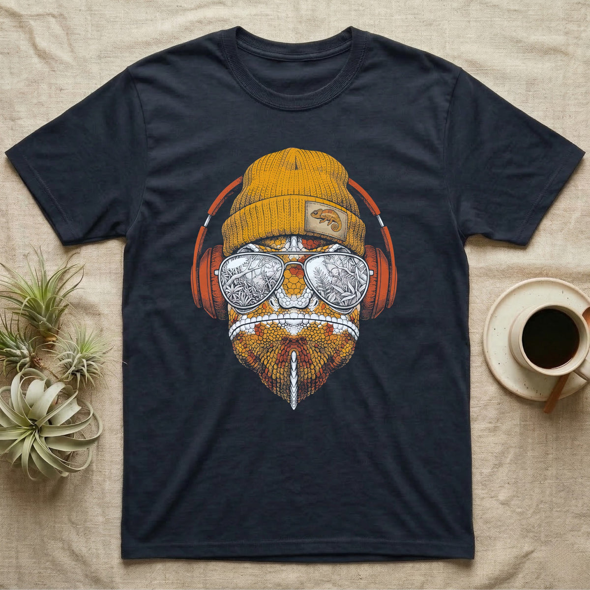 Chameleon Chill Vibes T-Shirt in Navy — Engraved chameleon with patterned orange skin in a beanie and headphones, aviators reflecting a jungle canopy.