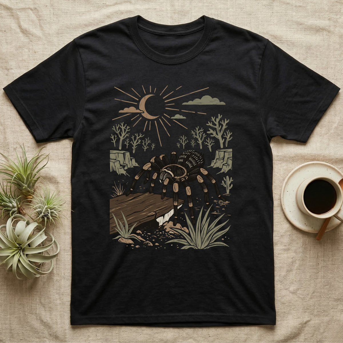 Red-Knee Tarantula Home Range T-Shirt in Black — Woodcut-style illustration of a Mexican red-knee tarantula at its burrow entrance under a rock slab with desert scrub behind, no on-shirt text.