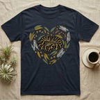 Dark t-shirt with a coiled snake design framed by leaves and branches in a heart shape.