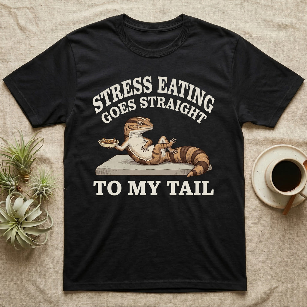 Fat-Tailed Gecko Snacking T-Shirt in Black — Engraved fat-tailed gecko lounging on a stone with mealworms under Stress Eating Goes Straight To My Tail