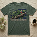 Green Anole 1776 T-Shirt in Military Green — Realistic green anole with a red dewlap on a branch over a distressed flag under text Land of the Free, Home of the Green.