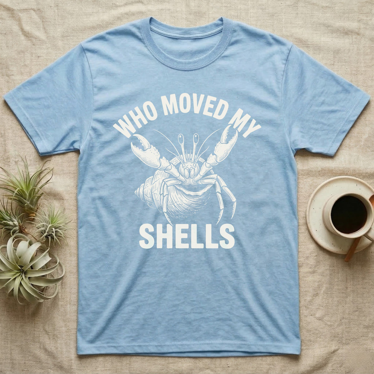 Hermit Crab Outrage T-Shirt in Light Blue — White-line engraving of a hermit crab flinging both claws up under the words Who Moved My Shells