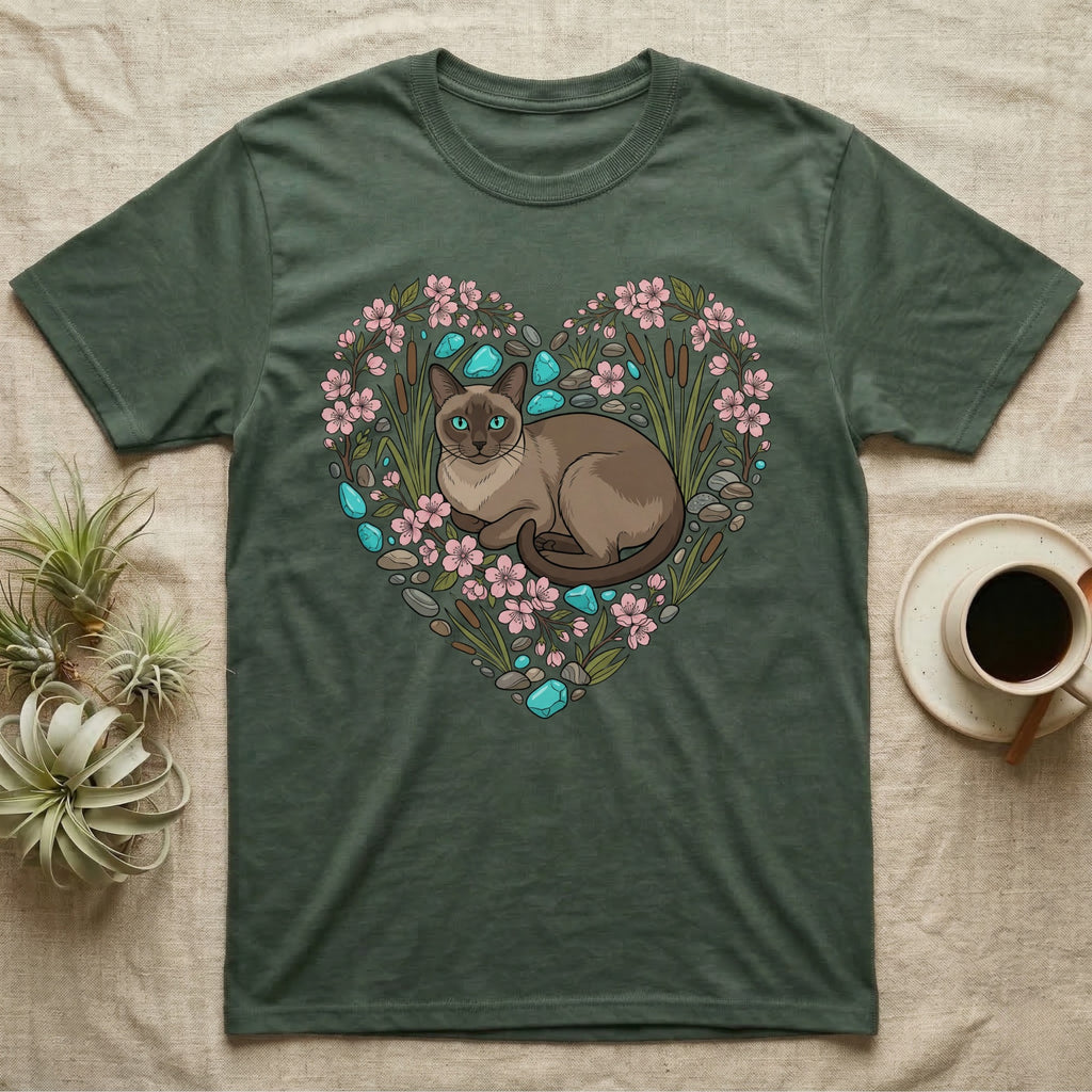 Green t-shirt with heart design of a cat, flowers, and stones.