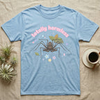 Tailless Whip Scorpion Baby T-Shirt in Light Blue — Pastel tailless whip scorpion with long whip legs among leaves and blossoms, puffy pink wordmark "totally harmless" above.