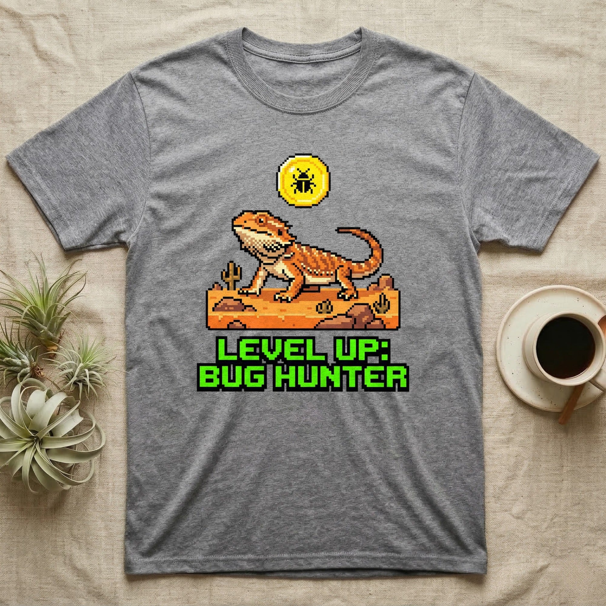 Grey t-shirt with pixelated lizard, bug, and text "LEVEL UP: BUG HUNTER".