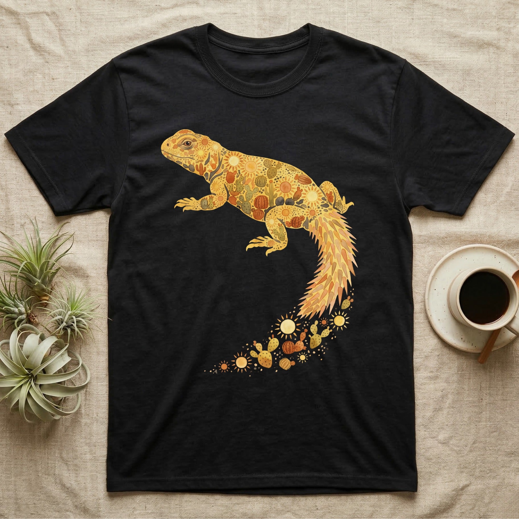 Uromastyx Solar Loaf T-Shirt in Black — Warm watercolour mosaic of a basking uromastyx lizard made of tiny suns, cacti and sand on grey