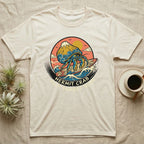 Cream t-shirt with a hermit crab surfing at sunset graphic.