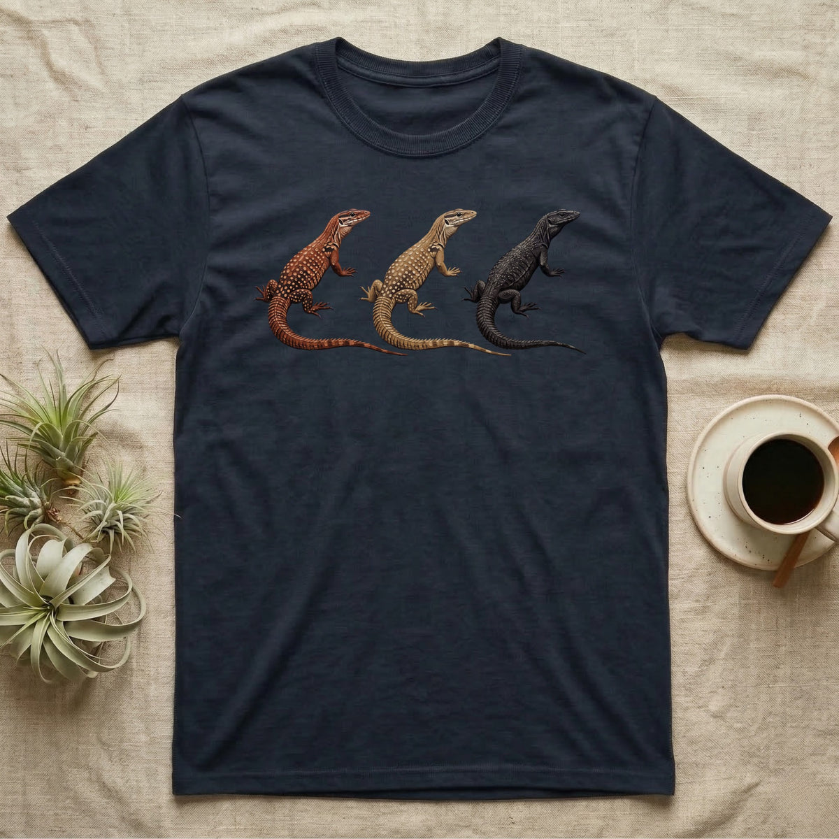 Ackie Monitor Triptych T-Shirt in Navy — Three ackie monitors in a row, painted in thick impasto — red, yellow and dark island forms with pale ocelli.