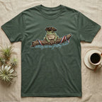 Tree Frog Freedom T-Shirt in Military Green — Detailed green tree frog in a tricorn hat on a ribboned branch under script Celebrating 250 Years of Freedom.