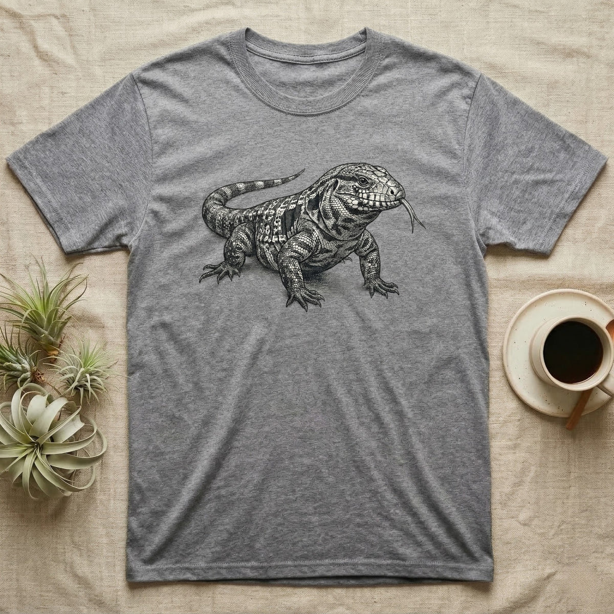 Gray t-shirt with black and white drawing of a tegu lizard and a cup of coffee.