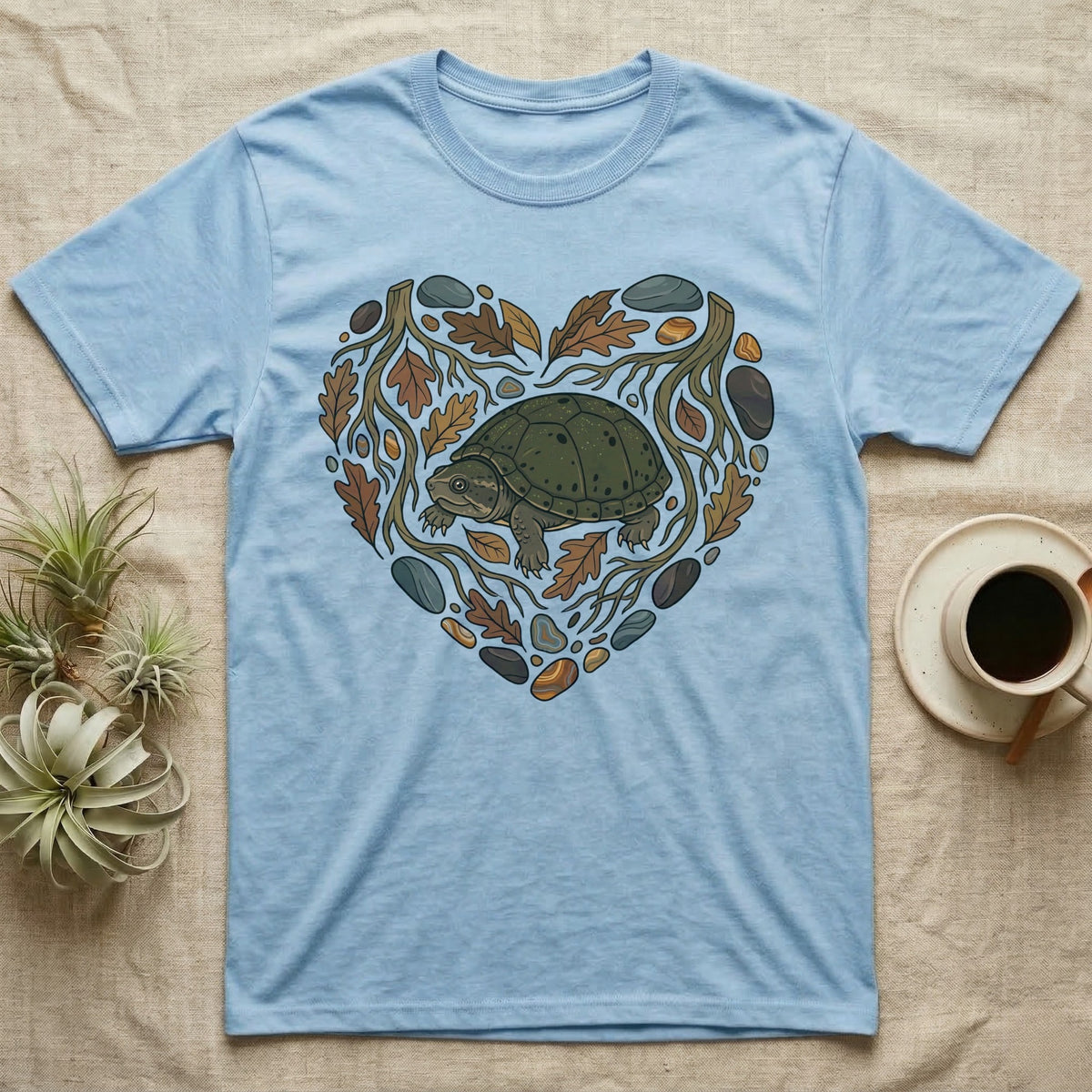 Light blue t-shirt with a heart-shaped nature design featuring a turtle.