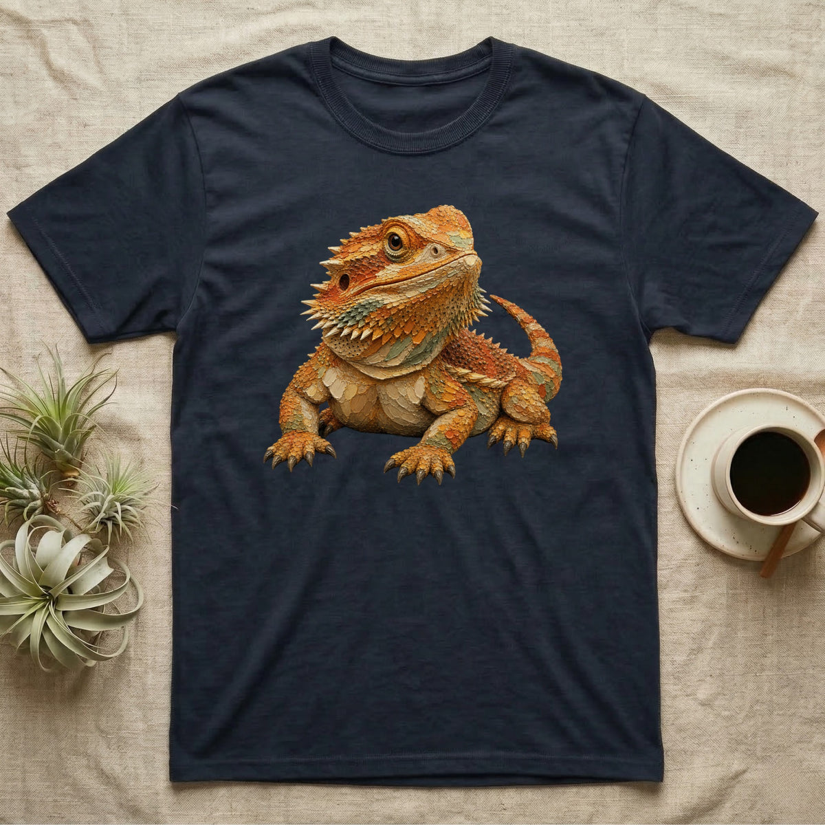Dark t-shirt with a detailed, vibrant illustration of a bearded dragon.