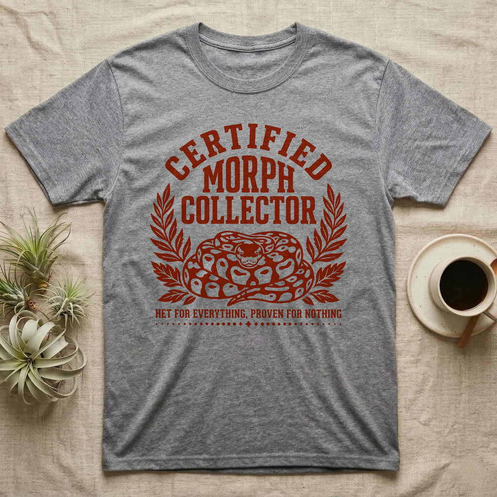 Ball Python Morph Crest T-Shirt in Sport Grey — Linocut-style crest illustration of a coiled ball python with an arched "Certified Morph Collector" headline in rust ink.