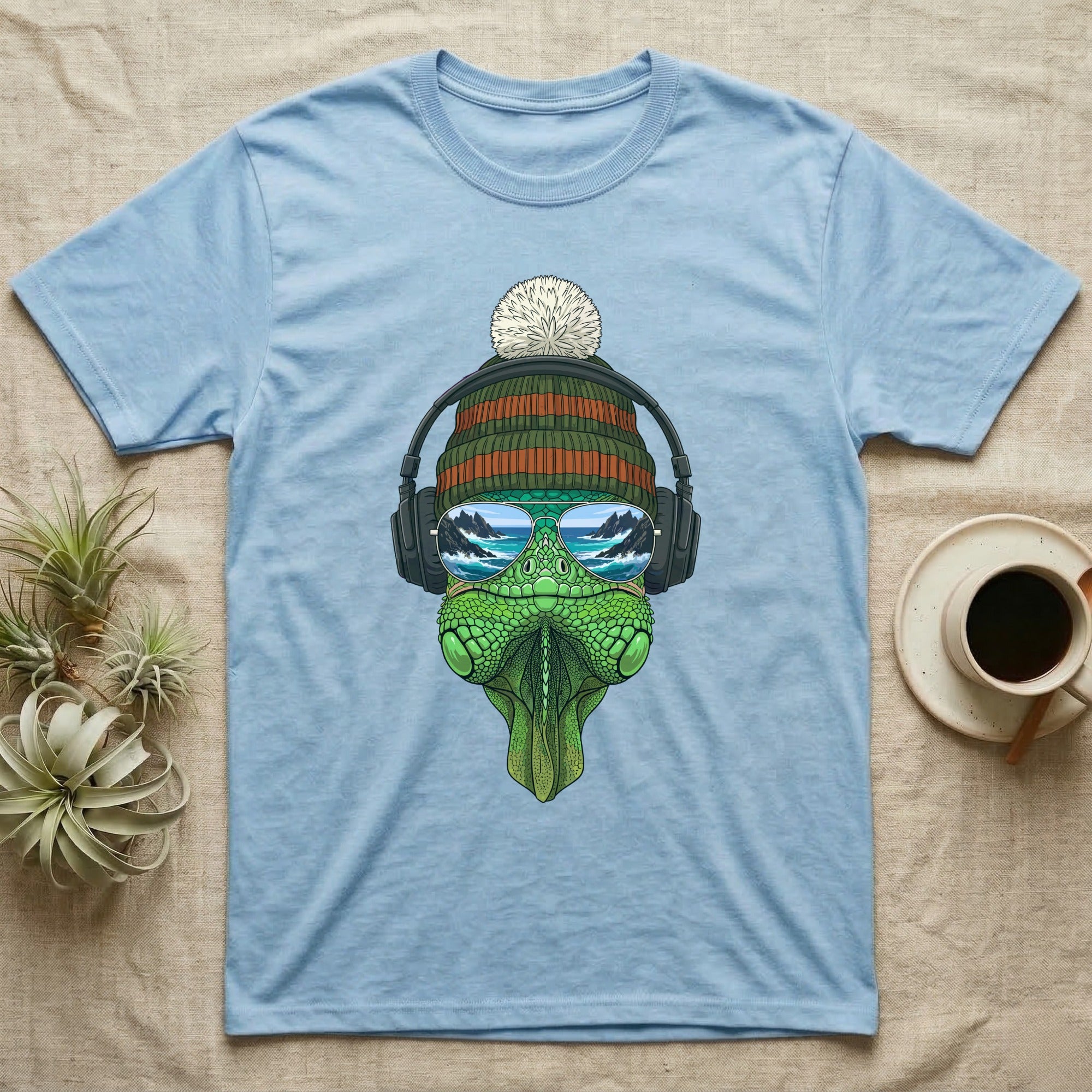 Light blue t-shirt with sunglasses, headphones, and a beanie-wearing lizard illustration.