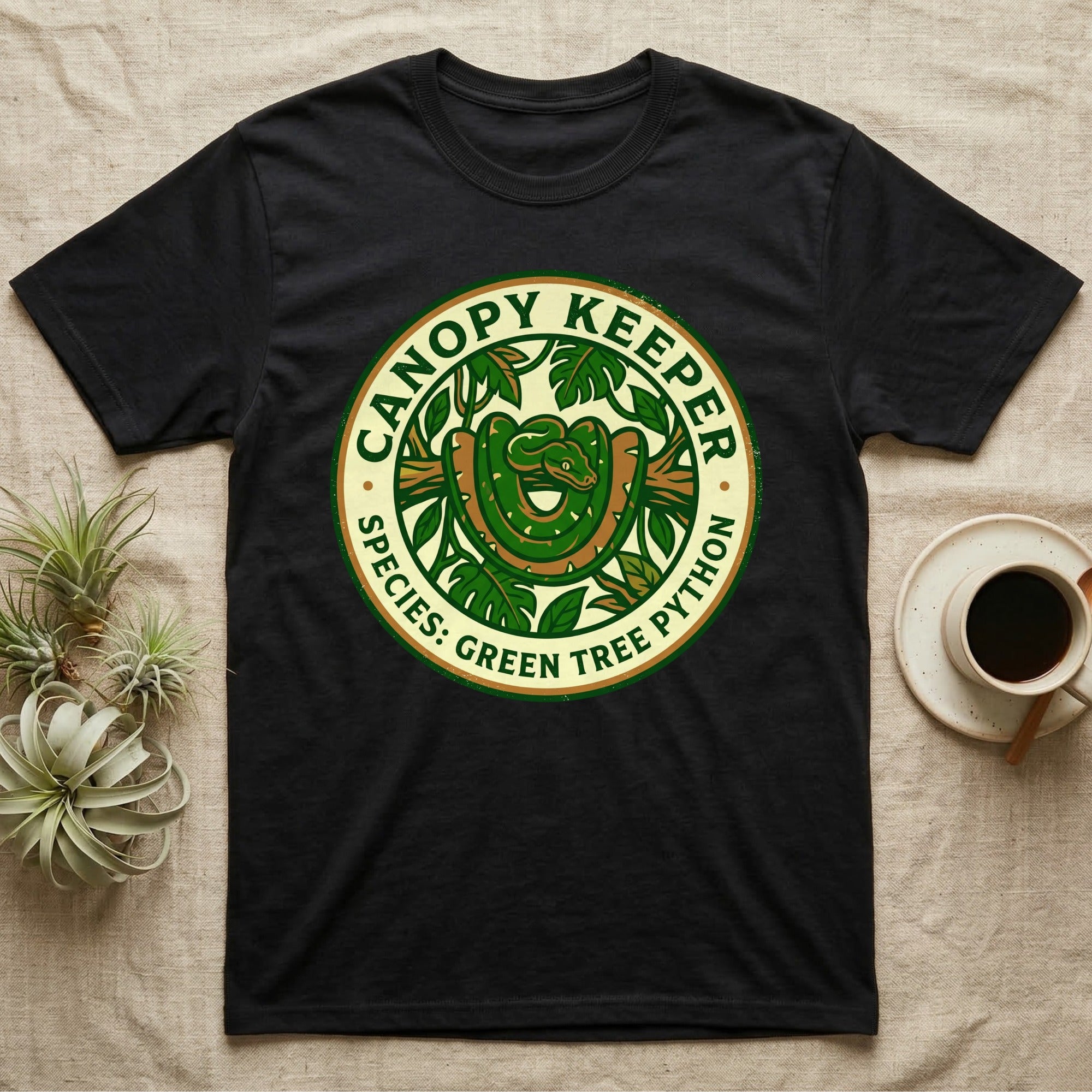 Black t-shirt with a green tree python graphic and "Canopy Keeper" text.