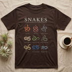 Snake Species Chart T-Shirt in Dark Chocolate — Watercolour chart of nine named North American snakes under a cream serif Snakes title on charcoal grey