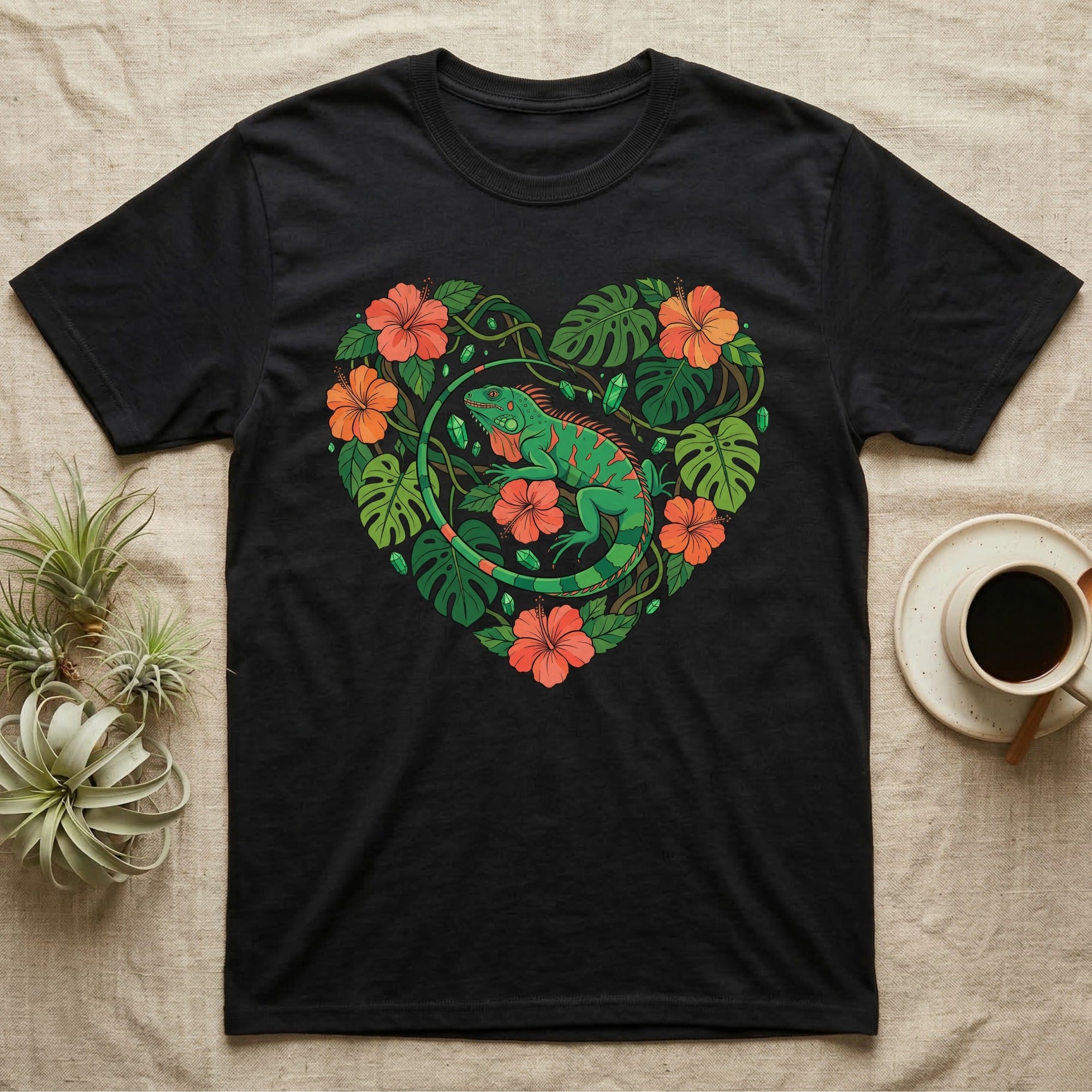 Black t-shirt featuring a green iguana surrounded by tropical leaves and red hibiscus flowers.