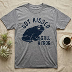 Tree Frog Kissed T-Shirt in Sport Grey — Worn navy silhouette of a dumpy White's tree frog under the words Got Kissed Still A Frog