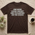 Reptile Loose Cricket T-Shirt in Dark Chocolate — Bold white capital letters stacked in four lines reading ONE MORE LOOSE CRICKET AND I'M SLEEPING ON THE COUCH