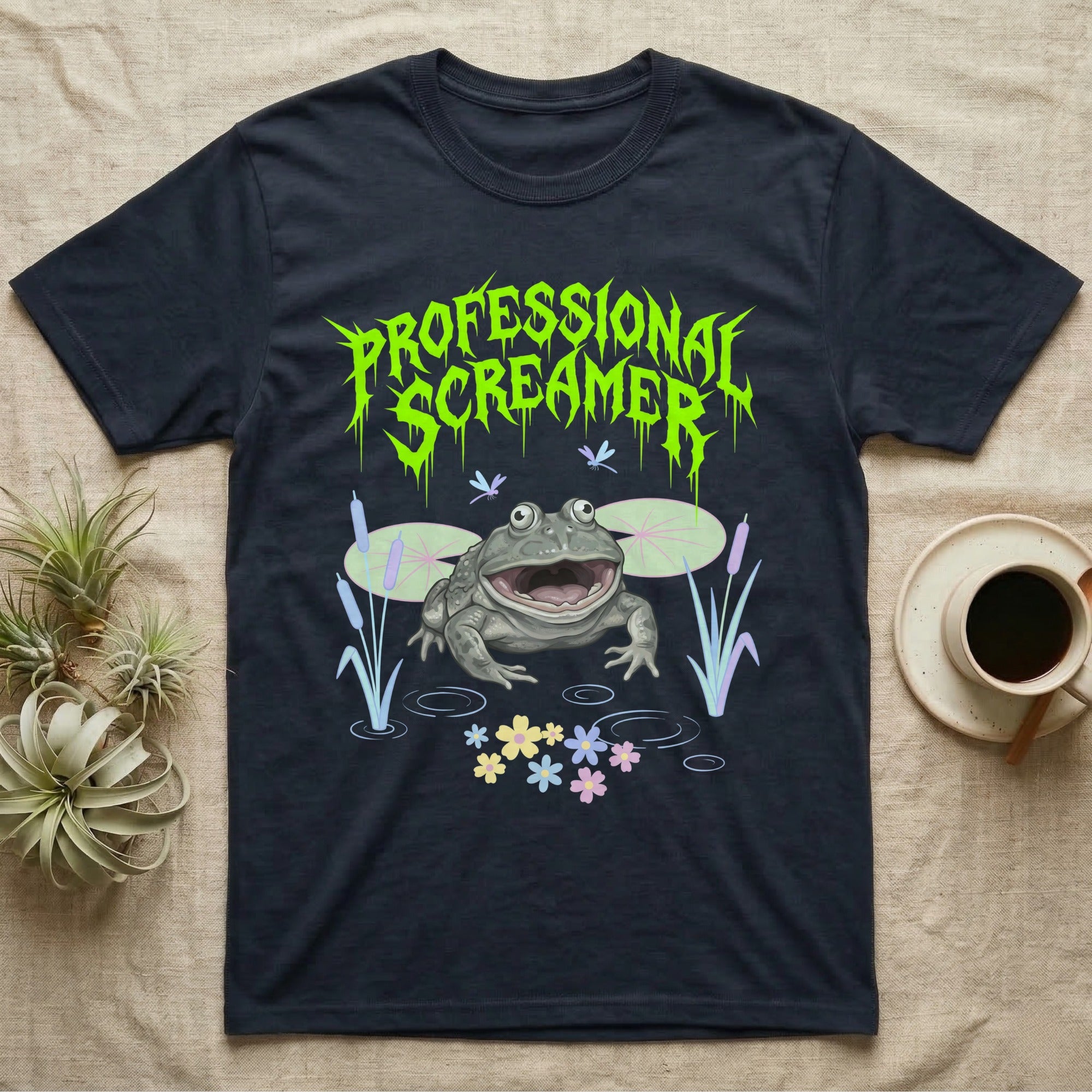 Budgett's Frog Feral T-Shirt in Navy — Budgett's frog with wide screaming mouth under jagged acid-green metal text PROFESSIONAL SCREAMER with lily pads