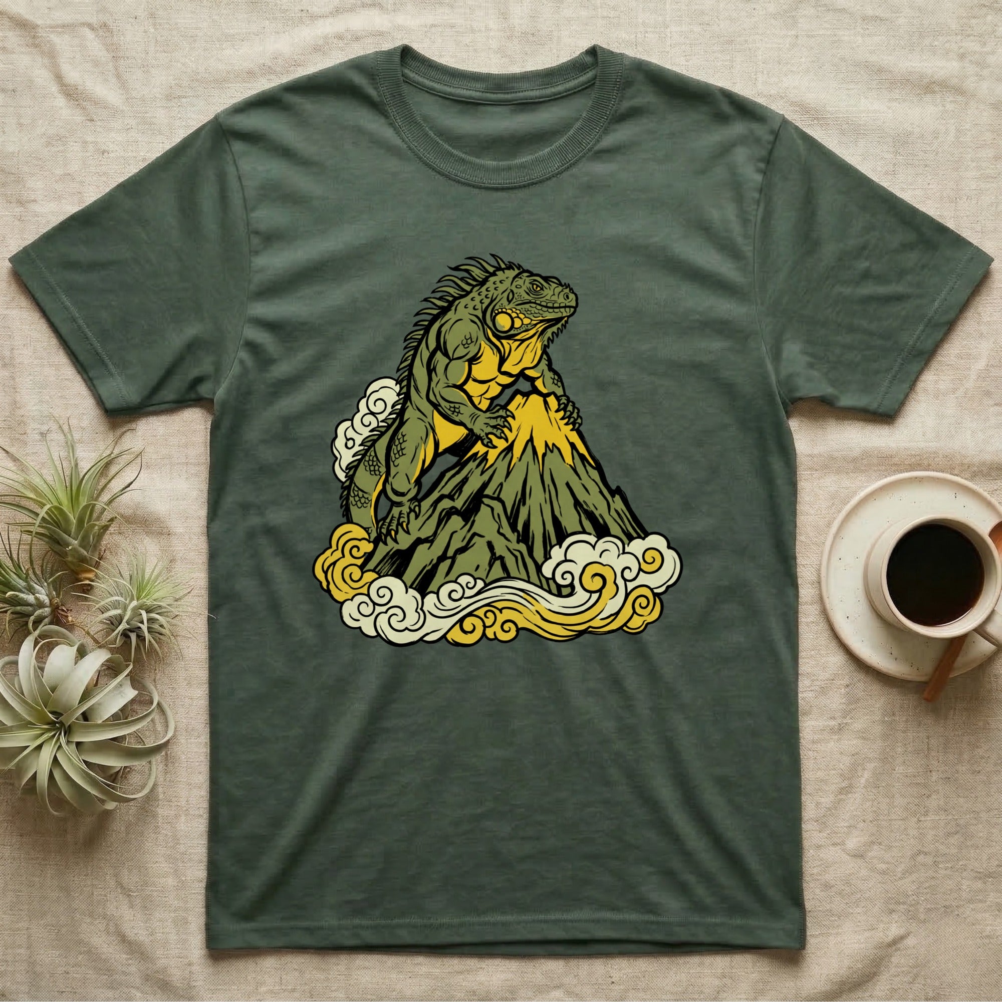 Green t-shirt with a lizard on a mountain and clouds graphic.