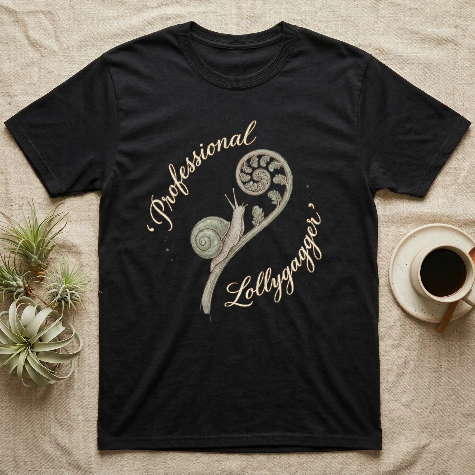 Black t-shirt with "Professional Lollygagger" text and a snail on a fern frond.